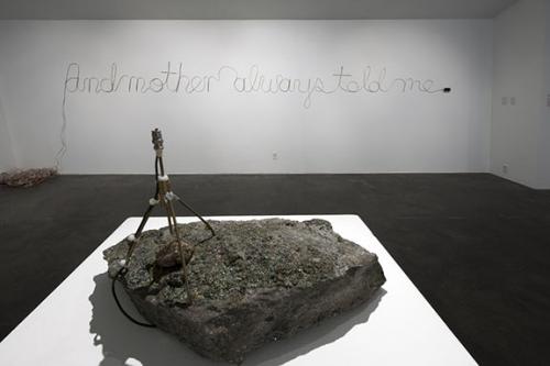 Installation view of Dove Bradshaw, <em>Radio Rock</em>, 1998, Pyrite, igneas rock, mixed media, radio, and speakers, 13 x 19 x 11 in., Courtesy the Artist and Larry Becker, Philadelphia, PA and Daniel Perlin, And Mother Always Told Me, 2009, Speaker wire and mp3 player, 72 x 24 x 224 in., Courtesy the Artist. Photo: Wayne McCall