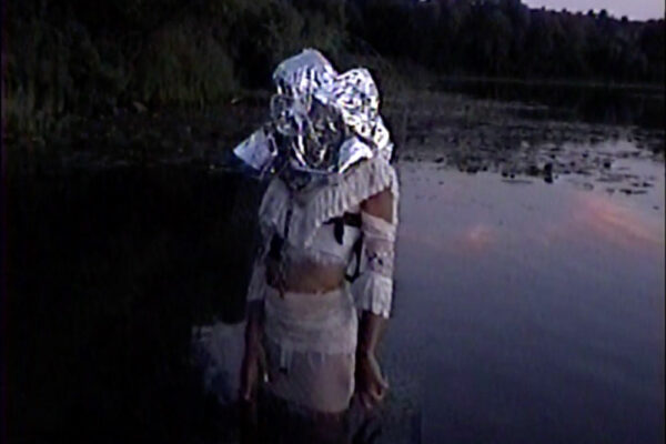 Cameron Patricia downey slider, person standing in water with metallic bag over their head